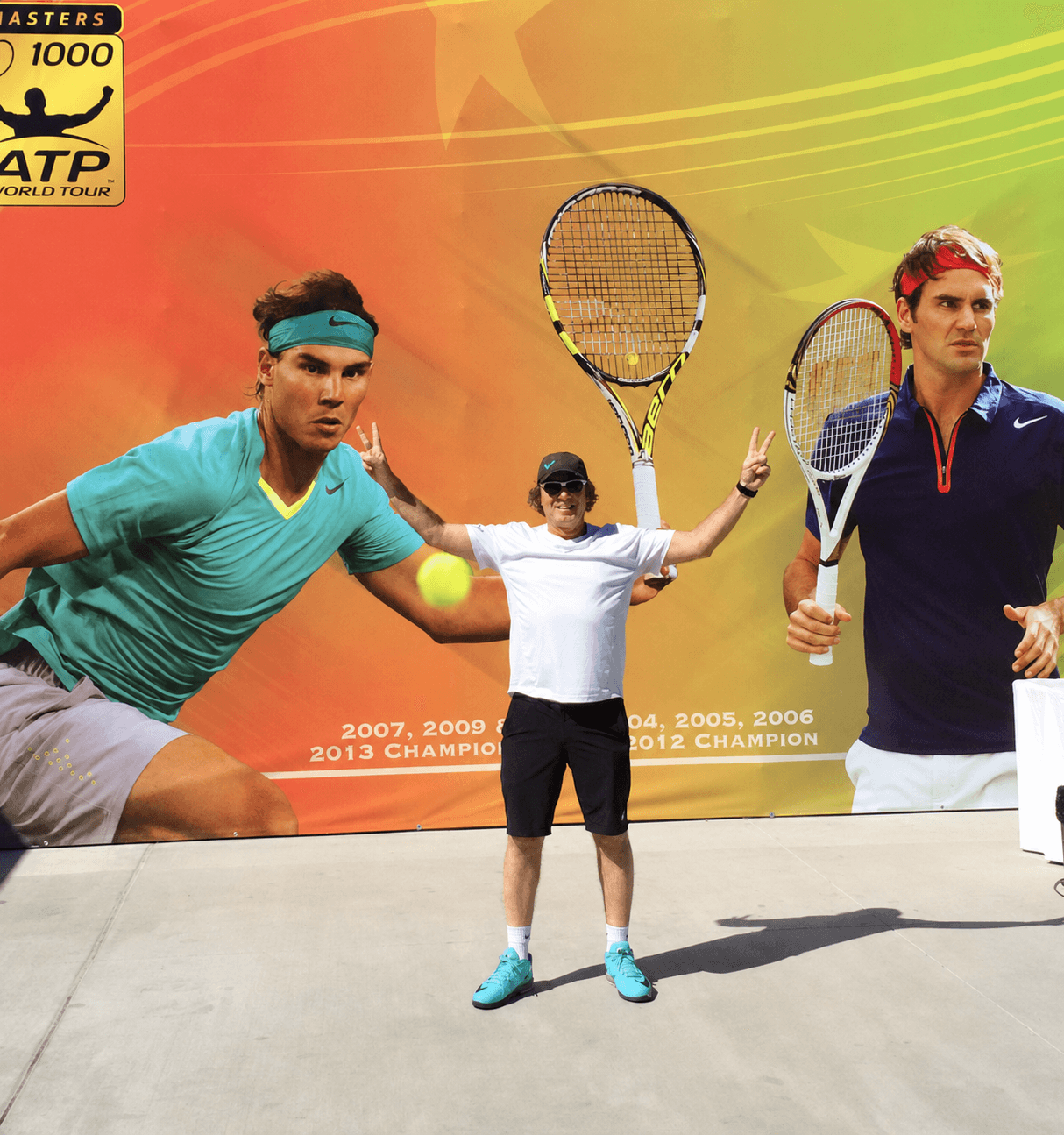 Jorge Pensky standing in front of a tennis mural