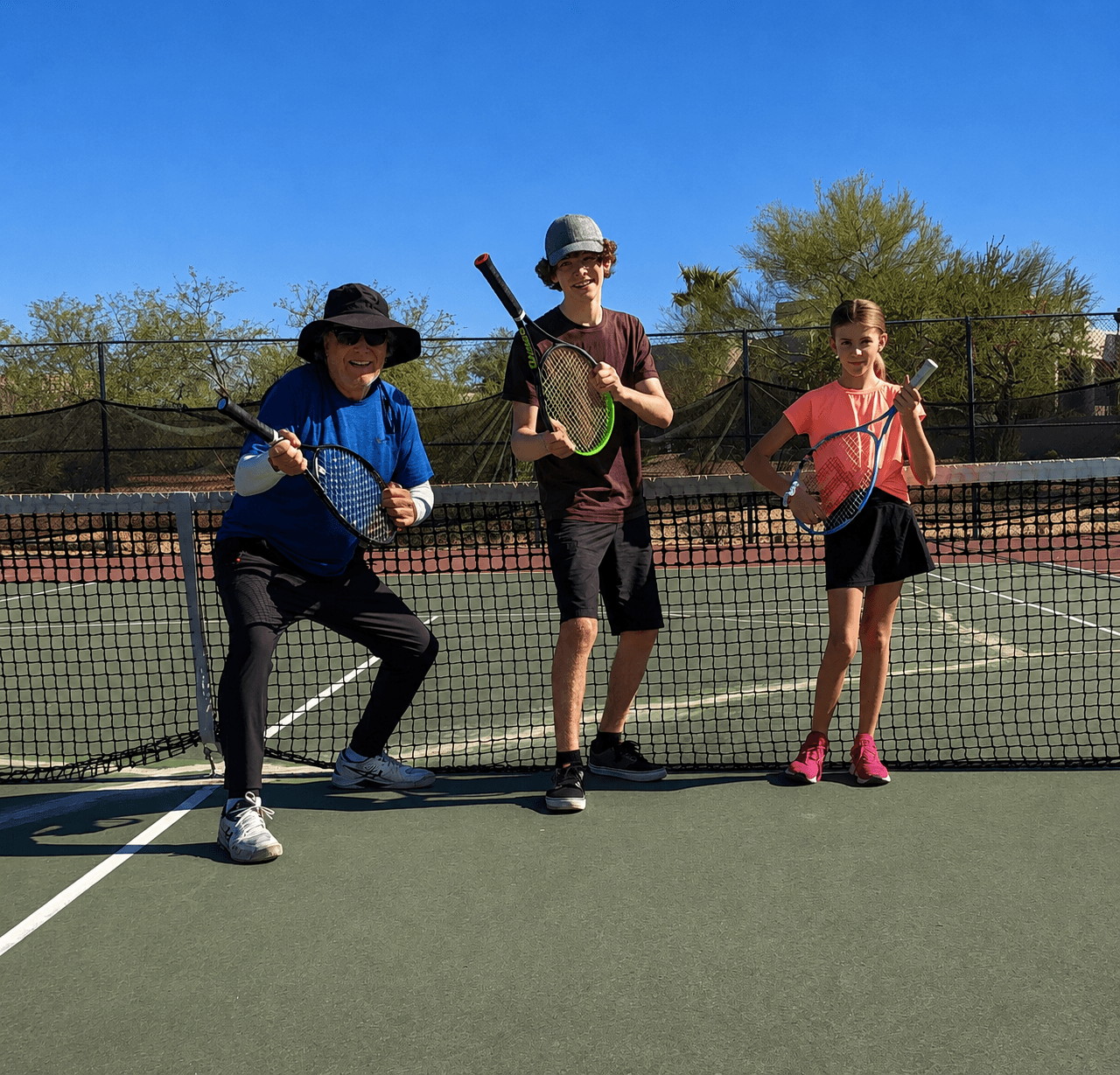 Young tennis players in a small group lesson